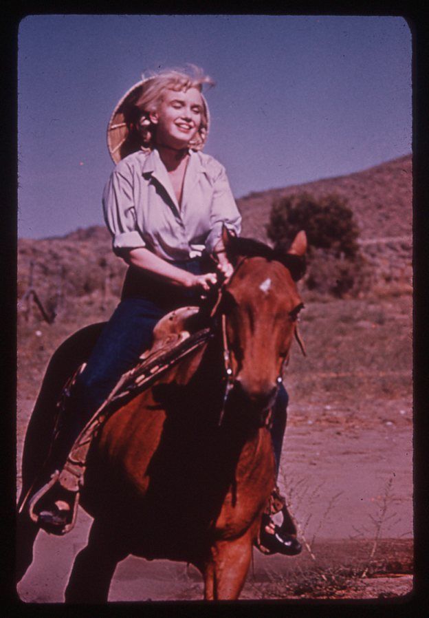 Marilyn Monroe riding a horse during the filming of The Misfits